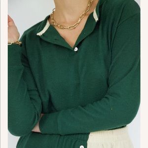 DONNI Henley sweater in green.